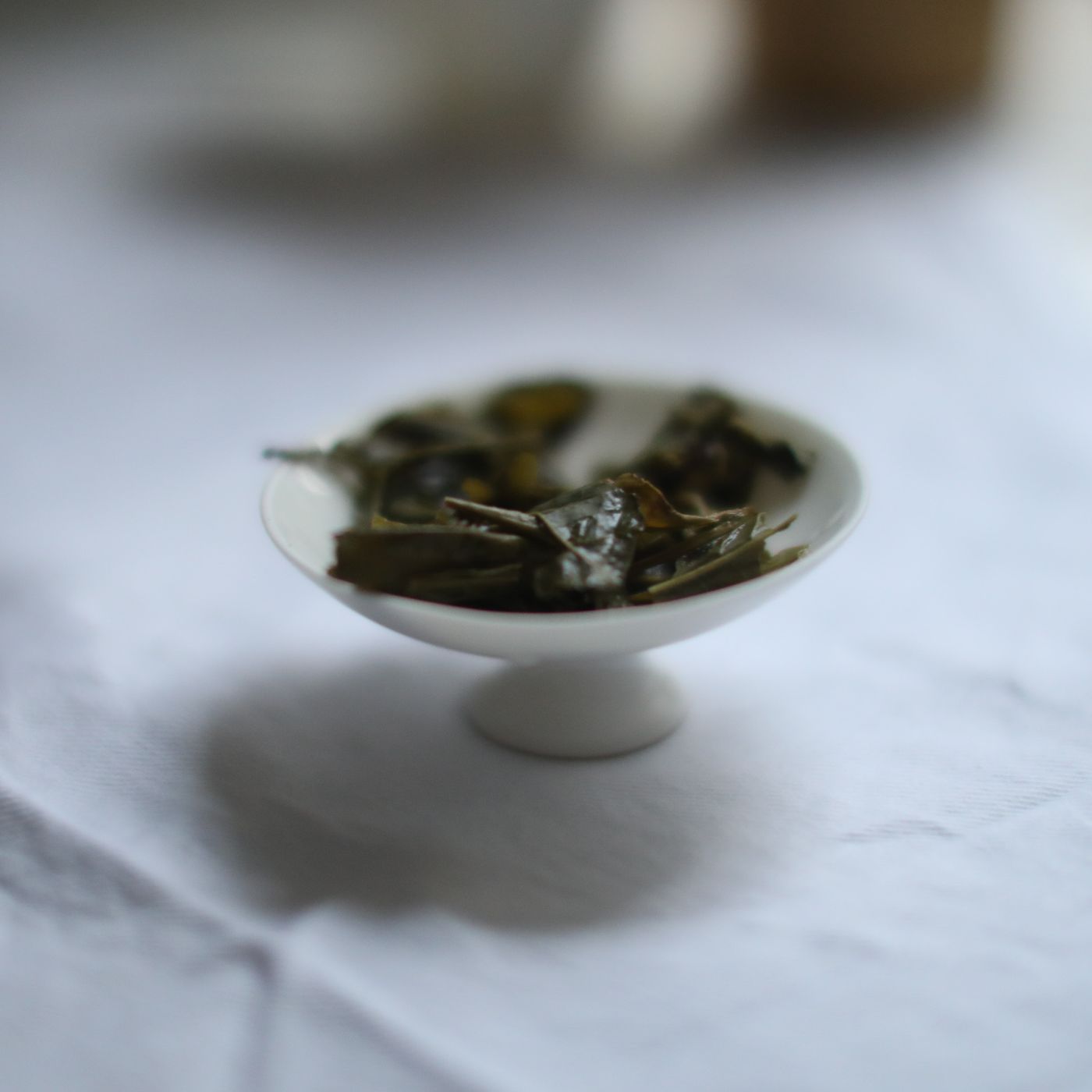 The liquor of the Yunnan Silver Needle white tea in a pale blue and black cup