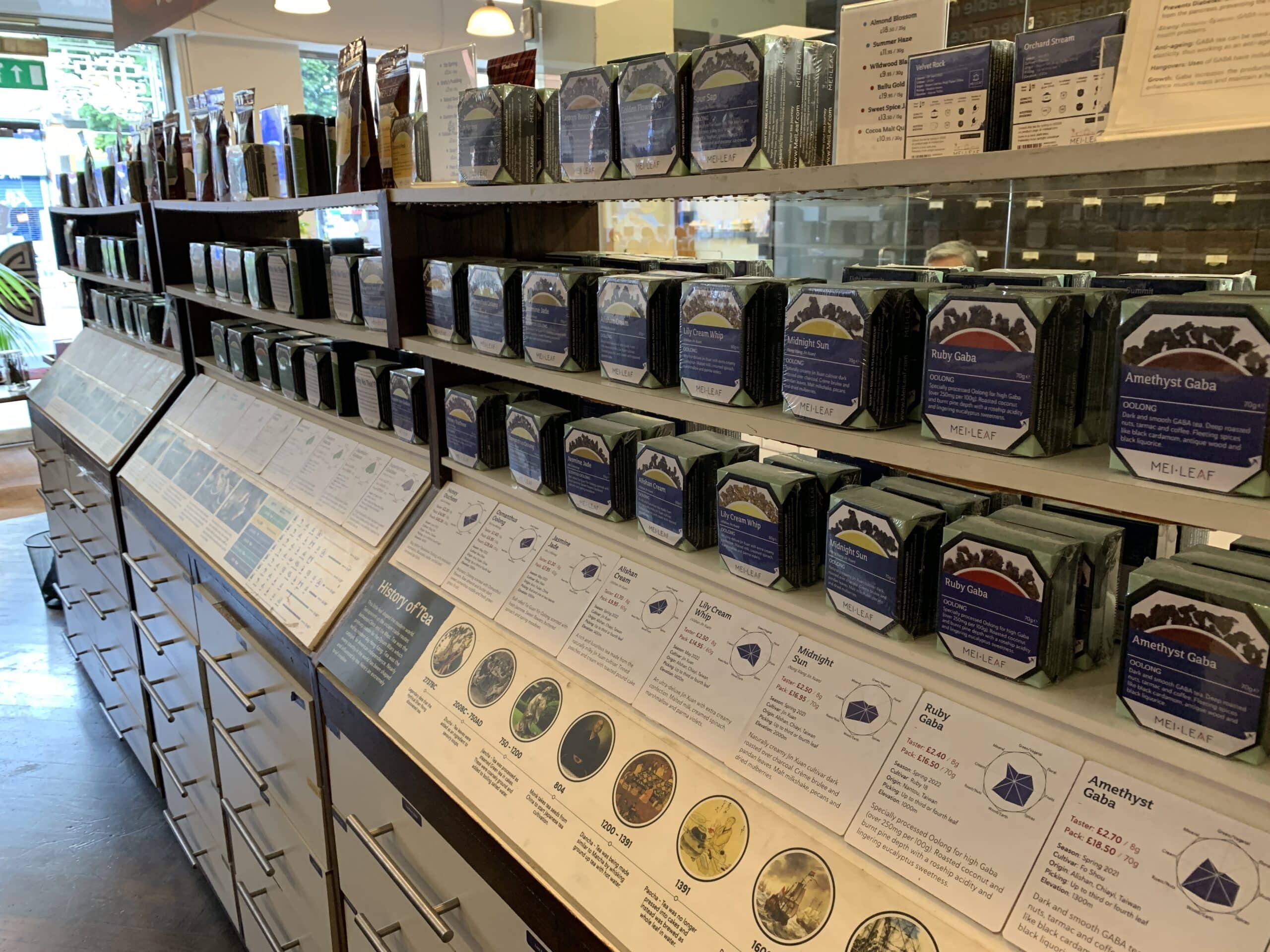 A view of a shelf full of tea and the flavor profiles of each tea at Mei Leaf, a tea shop in London