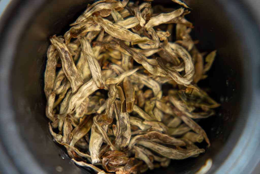 Buds of the Yunnan Silver Needle white tea from Tea Shop from above.
